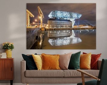 Illuminated Antwerp Port House at night reflected in a canal  by Tony Vingerhoets