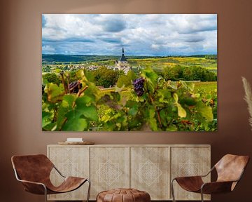 View of a village in the Champagne region of France with grapes in the foreground by Ivo de Rooij