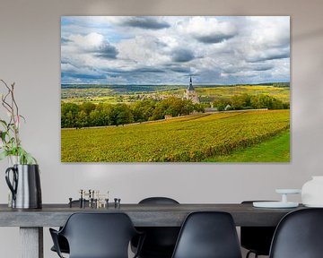 View of a village in the Champagne region of France with grapes in the foreground by Ivo de Rooij