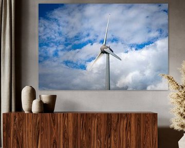 Wind turbine with a blue sky and clouds above by Sjoerd van der Wal