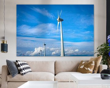 Row of wind turbines in a windpark with a blue sky and clouds above by Sjoerd van der Wal