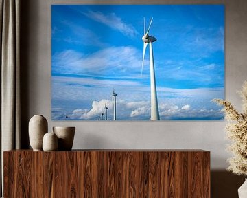 Rij van windturbines in een windpark met een blauwe lucht en wolken van Sjoerd van der Wal