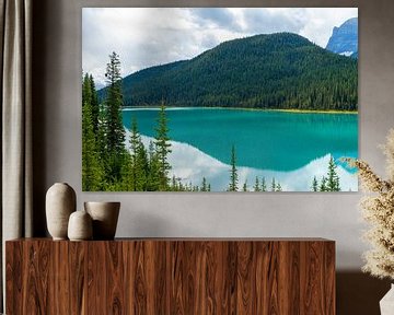 Bow Lake with turquoise water and forested mountain in the background by Hans-Heinrich Runge