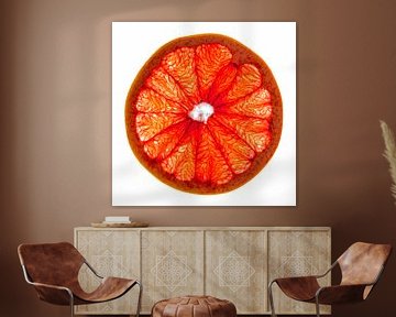 Close-up van een schijfje grapefruit met een witte achtergrond. van Carola Schellekens