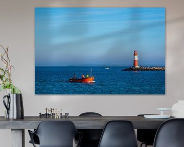 Pier on the coast of the Baltic Sea with fishing boat in Warnemünde by Rico Ködder