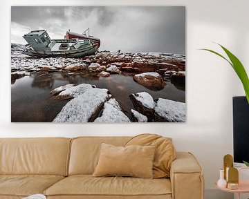 Shipwreck in the snow on rocks in Greenland by Martijn Smeets