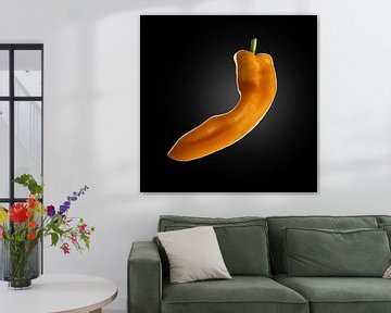 Orange pointed pepper on black background by Everards Photography