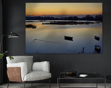 High tide Ooijpolder with boats and duck in the setting sun by Machiel Zwarts
