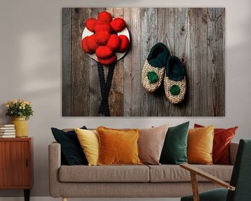 old Bollen hat with straw shoes in front of wooden wall by Jürgen Wiesler