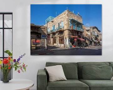 Oud pand met blauwe schermen en winkels in oude stad Jaffa, Tel-Aviv, Israel van Joost Adriaanse