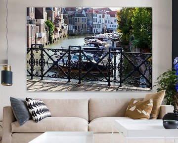 Cast iron fence of a bridge with a harbour and houses in the background in Dordrecht by Peter de Kievith Fotografie