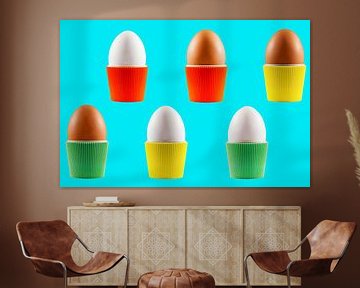 Coloured vintage egg cups with eggs on a blue background by Peter de Kievith Fotografie