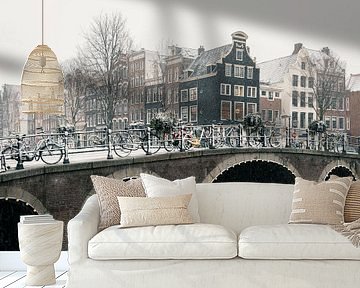 Bridge and canal houses in Amsterdam in the snow by iPics Photography