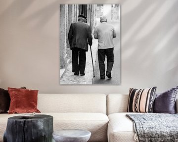 Old men walking through Lisbon black and white by Monique Tekstra-van Lochem