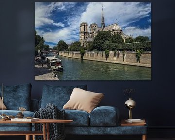 Boats along the banks of the Seine and Notre Dame cathedral in Paris, France