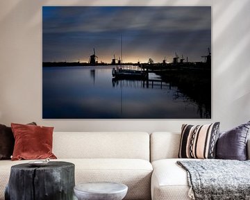 Historic Dutch windmills along a wide canal at Kinderdijk by Tjeerd Kruse