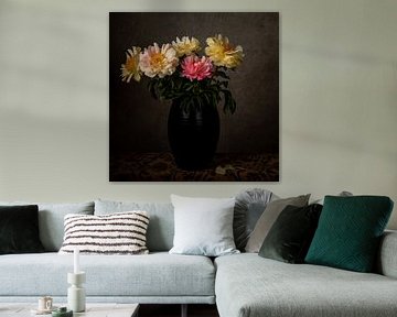 Peonies in black vase on table by Matty Maas