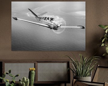 Vintage Beechcraft Bonanza airplane over the sea by Planeblogger