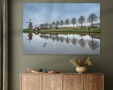 View of the town wall of Dokkum with windmill and row of trees by Harrie Muis