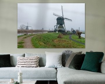 Molen Kinderdijk in de mist van Merijn Loch