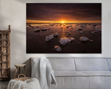 The Wadden Sea is covered with ice floes in the winter. A beautiful sunset gives beautiful colors in by Bas Meelker