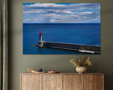 Lighthouse in front of calm deep blue sea by Fartifos