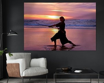 Young samurai woman with japanese sword(Katana) at sunset on the beachunset on the beach by Eye on You