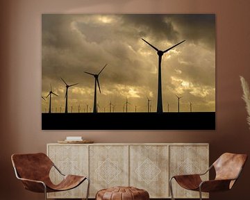 Wind park with rows of wind turbines during sunset by Sjoerd van der Wal