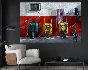 Work break bicycle and three wheelbarrows leaning against wall by Dieter Walther