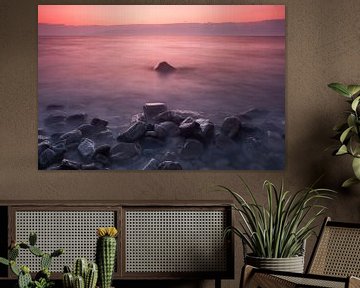 Bright pink sunset on lake baikal, stones in the foreground, long exposure by Michael Semenov