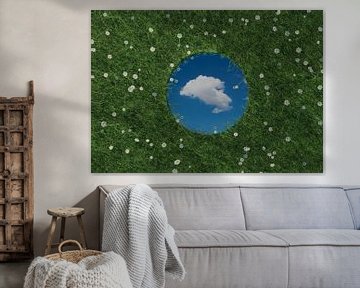 Round mirror reflects white single cloud and lies on green meadow surrounded by daisies by Besa Art