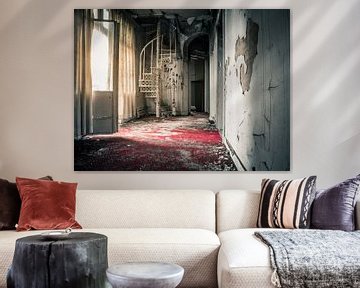 Red carpet and spiral staircase in dilapidated villa by Art By Dominic