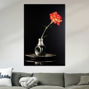 Green vase with orange carnation