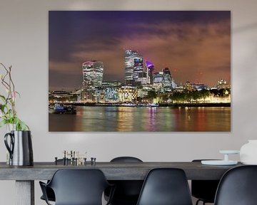 Night image of London skyline with reflections on the Thames - business district with many colorful  by MPfoto71