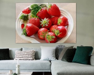 Fresh strawberries with crown on white dish by Ans van Heck