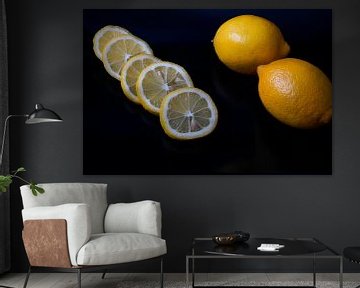 Citroen als hele vrucht en in plakjes gesneden op zwart serveerbord van Babetts Bildergalerie