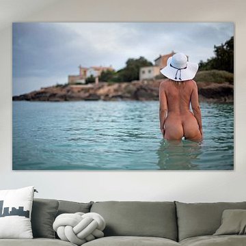 Young pretty woman naked at sunrise on Es Trenc beach in Mallorca