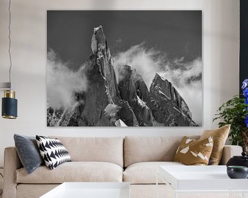 Mystic mountain: Cerro Torre in Patagonia surrounded by clouds, black and white by Christian Peters