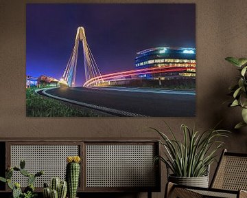 Lighttrail of a passing car at Ottergembrug with an illuminated building in the background. by Daan Duvillier | Dsquared Photography