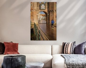 View of the Koppelpoort in Amersfoort with a jogger in the foreground. by Bart Ros