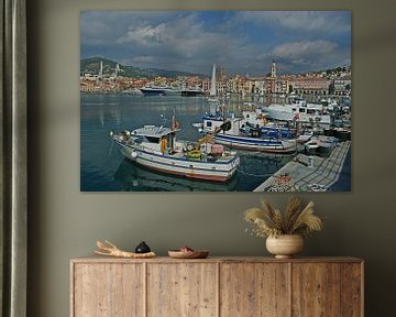 A port full of boats and yachts with town Imperia at the background. by Gert van Santen