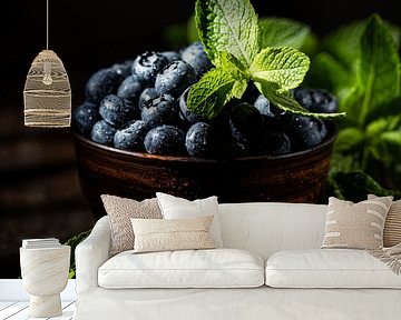 Blueberries with mint leaves in brown bowl by Iryna Melnyk