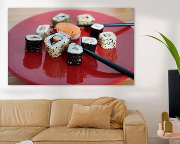 Sushi arranged on a red plate with chopsticks by Babetts Bildergalerie
