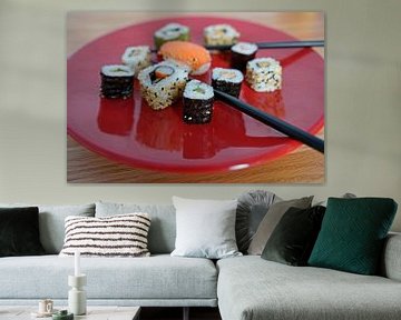 Sushi arranged on a red plate with chopsticks by Babetts Bildergalerie