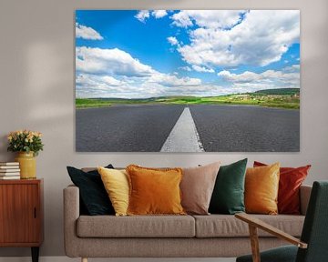 Asphalt road with white dividing lines, beautiful landscape and cloudy blue sunny sky by Alex Winter