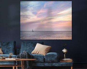 Sailing boat at sea during colourful sunset in Zeeland by Evelien Oerlemans