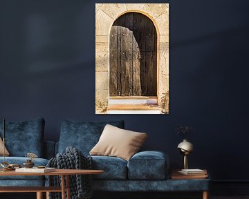 Close-up of old wooden front door residence entrance with stone arch by Alex Winter