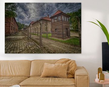 The watch tower and barbed wire fences of Auschwitz by Caught By Light