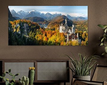 Panorama of Neuschwanstein castle, Marienbrücke bridge and Alpsee lake. Snow covered mountains in th