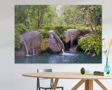 Small waterfall in the Philippines in the forest with palm trees